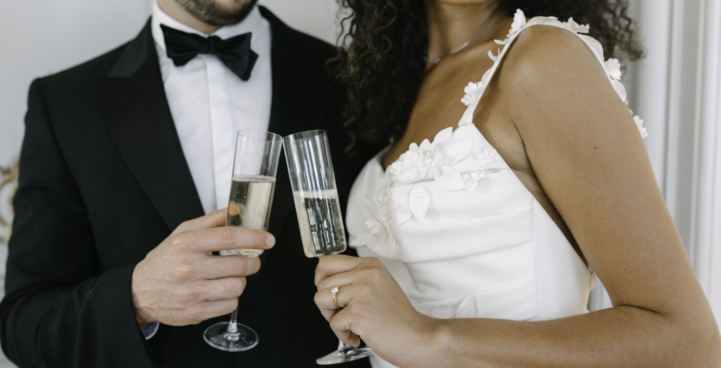 Bride and groom having a toast with champagne in a french chateau