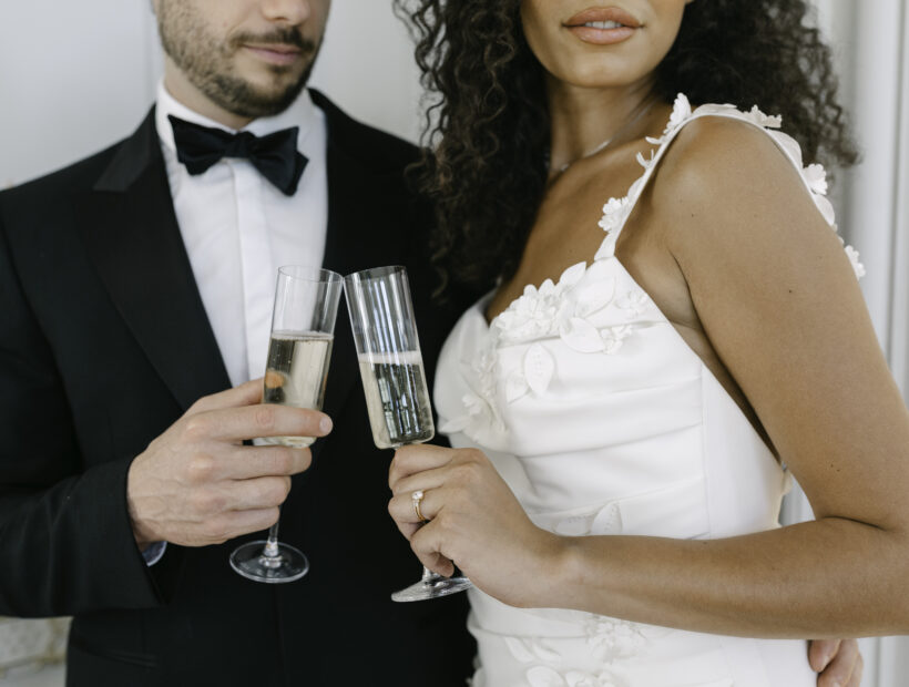 Bride and groom having a toast with champagne in a french chateau